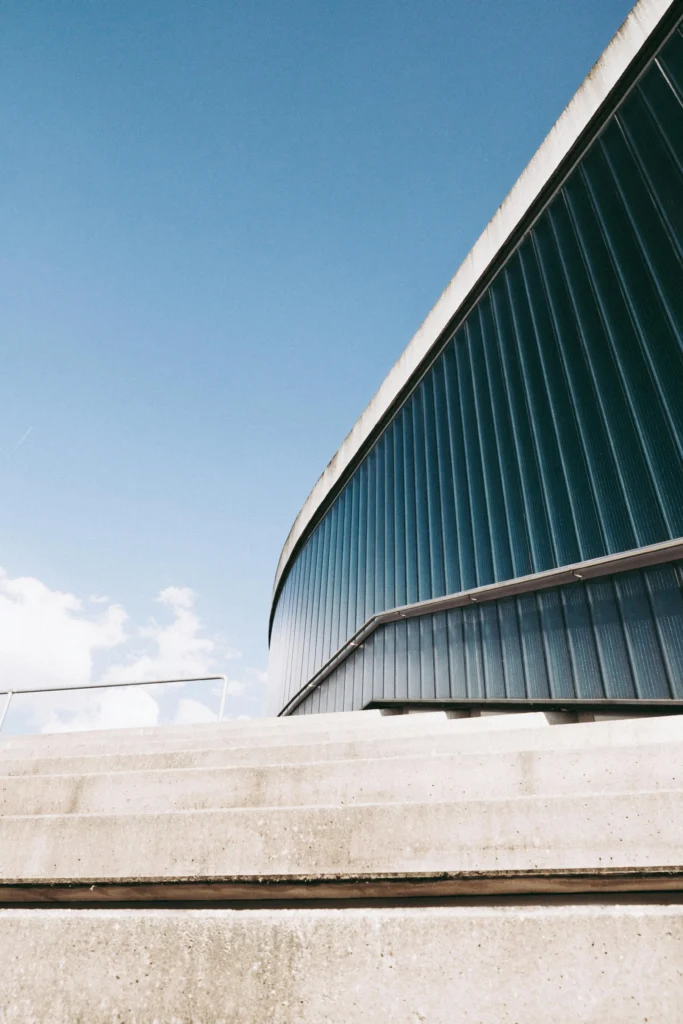 Modern glass architecture and concrete steps symbolizing the strategic foundation and upward vision of ORIGIN SWISS, a Geneva-based consulting firm.